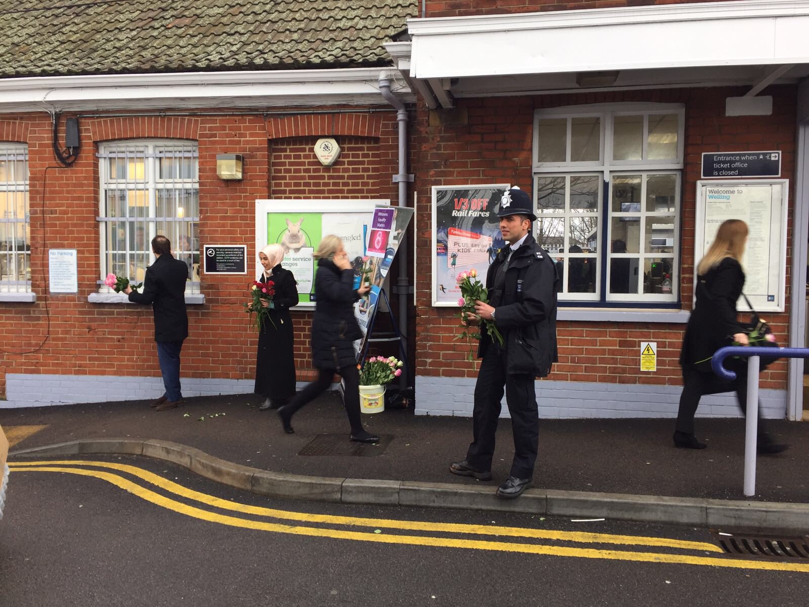 Police hand out roses at Welling station for International Women's Day